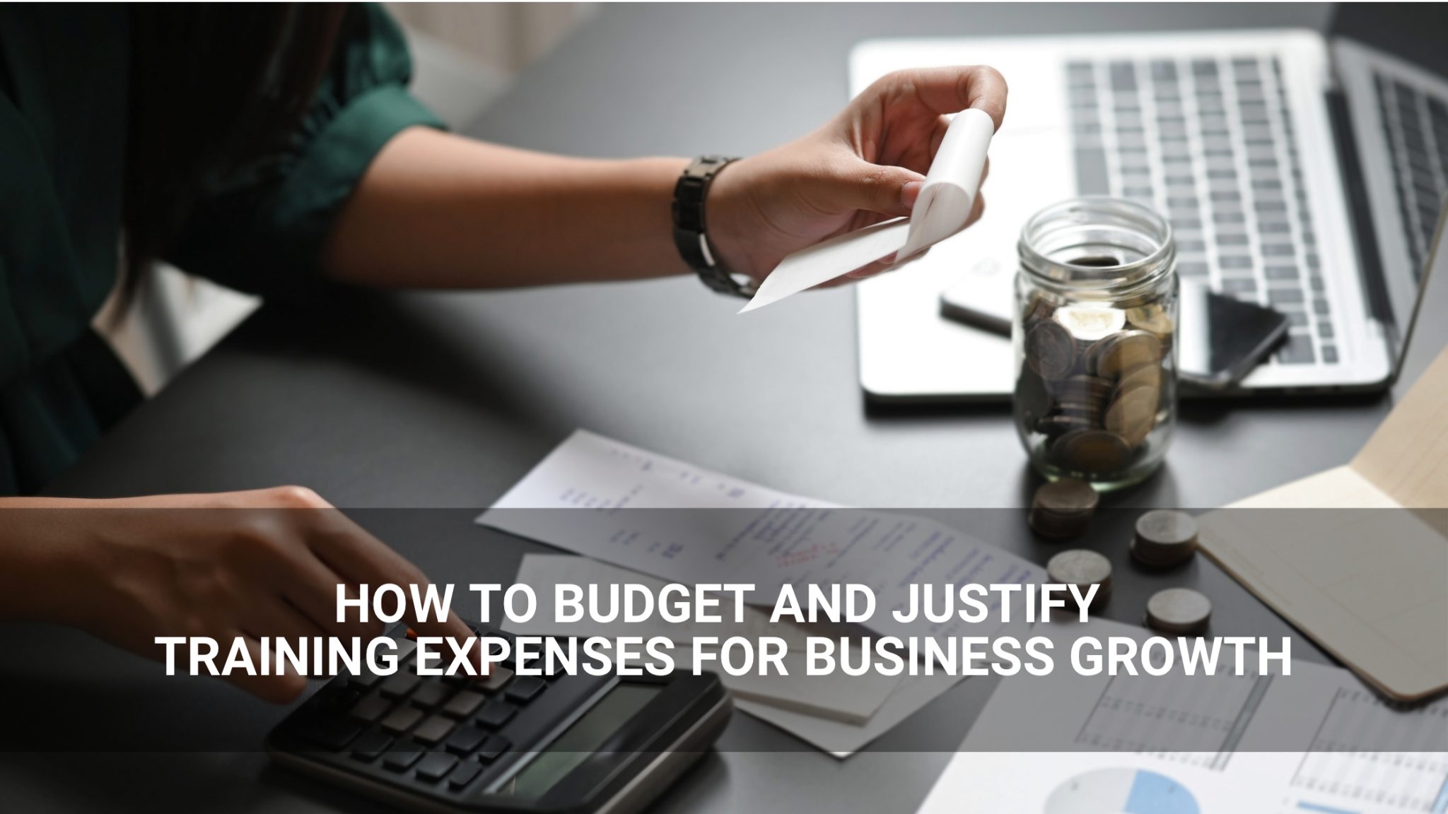 How to Budget Training Expenses and Justify Training Expenses for Business Growth - employee using a calculator to budget - Above Promotions