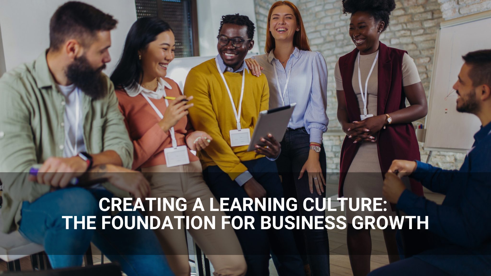 creating a learning culture: the foundation for business growth - employees gathered in discussion - Above Promotions