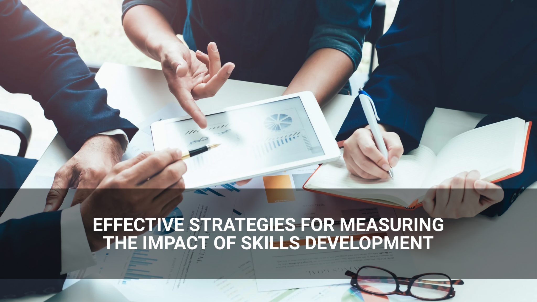 Effective Strategies for Impact Measurement in Skills Development” overlaid. - people reviewing charts- Above Promotions