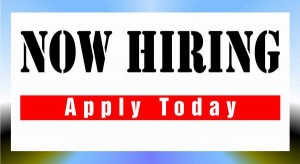 A "now hiring" sign with bold, black letters on a white background, and a red banner below it that reads "apply today" against a soft-focus blue-to-white gradient background designed for marketing roles.