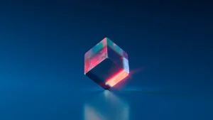 A transparent, floating cube with colorful light reflections against a dark blue background.