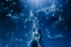 A robotic hand reaches towards a network of interconnected glowing nodes and lines against a blue background.