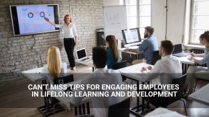 Can’t miss tips for engaging employees in lifelong learning and employee development. - employees gathered to look at graphs on screen. - Above Promotions