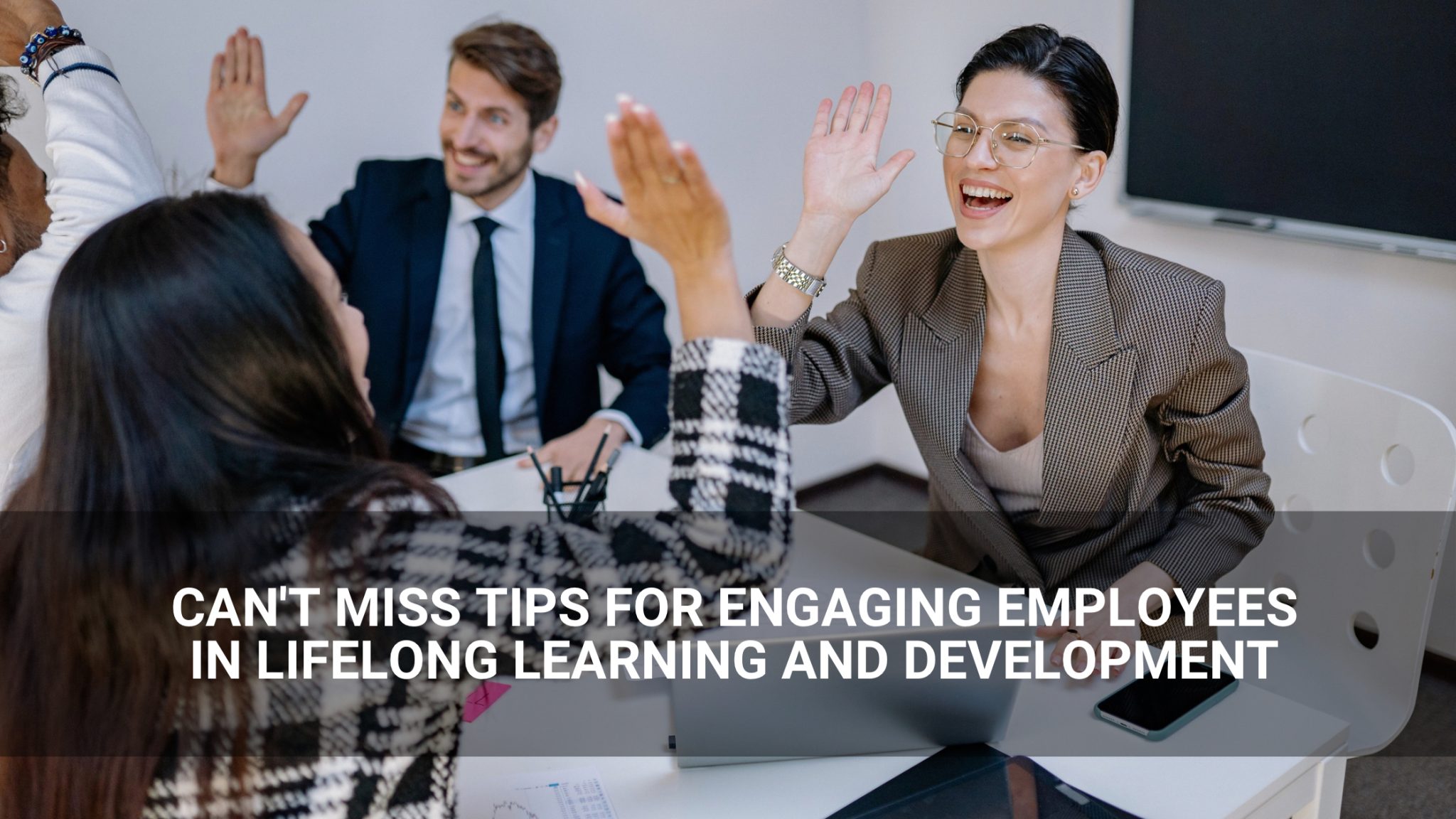 Can't Miss Tips for Engaging Employees in Lifelong Learning and Development - employees high-fiving- Above Promotions